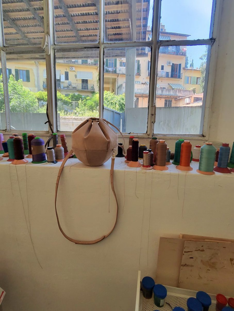 A Sunday bag resting on a workshop windowsill overlooking Florence